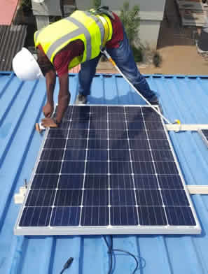 Man maintaining solar panel by solar energy company in nigeria